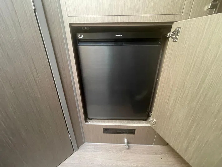  Yacht Photos Pics 2024 Beneteau Gran Turismo 32 interior with built-in compact refrigerator.