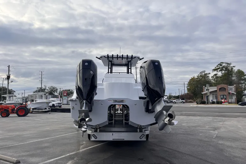  Yacht Photos Pics 2026 Invincible 33 Catamaran with dual outboard motors in a parking lot.