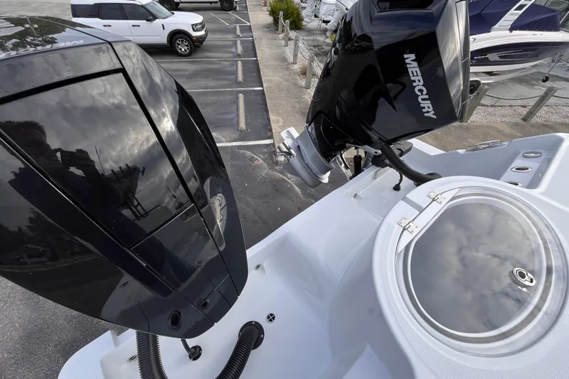  Yacht Photos Pics 2026 Invincible 33 Catamaran with Mercury outboard engines in a marina setting.