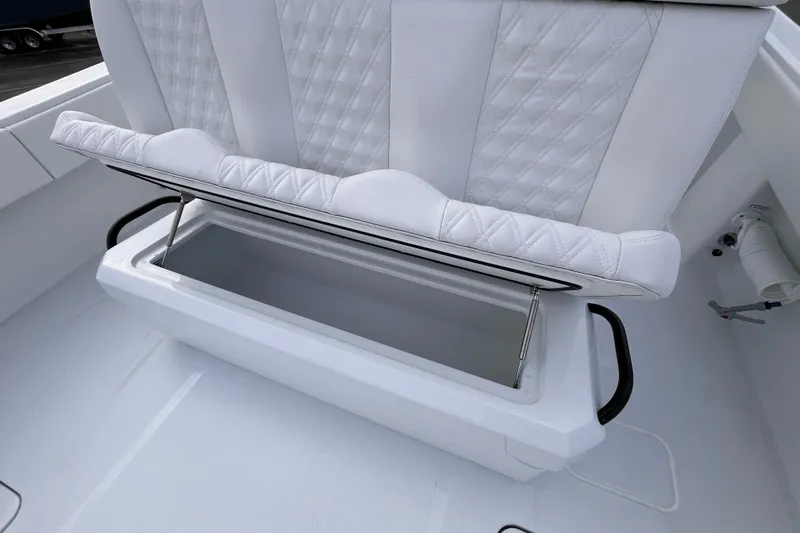  Yacht Photos Pics 2026 Invincible 33 Catamaran with open storage compartment and white quilted seating.