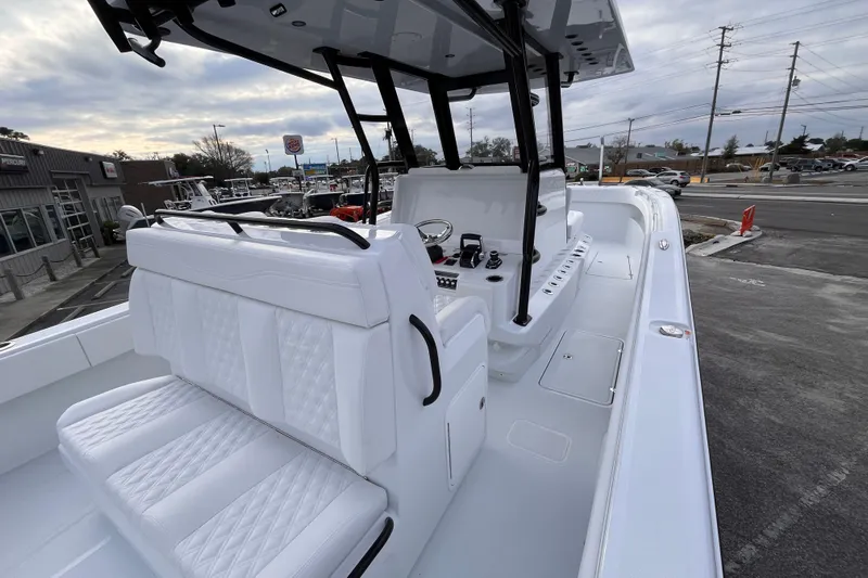  Yacht Photos Pics 2026 Invincible 33 Catamaran with sleek white interior and modern controls, docked outdoors.