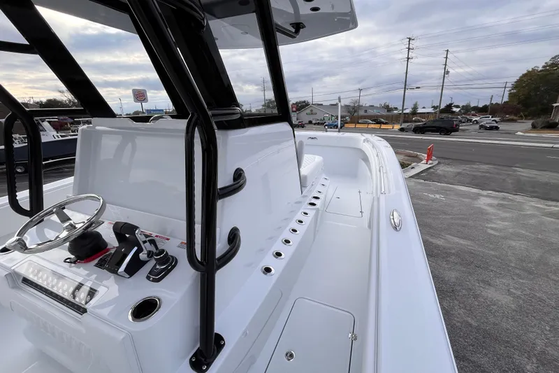  Yacht Photos Pics 2026 Invincible 33 Catamaran boat with sleek design and modern controls, parked outdoors.