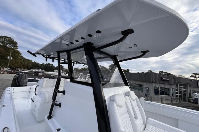  Yacht Photos Pics 2026 Invincible 33 Catamaran with sleek design and modern seating, docked outdoors.