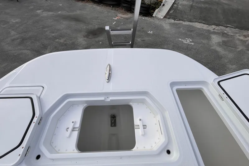  Yacht Photos Pics 2026 Invincible 33 Catamaran deck with open storage compartments.