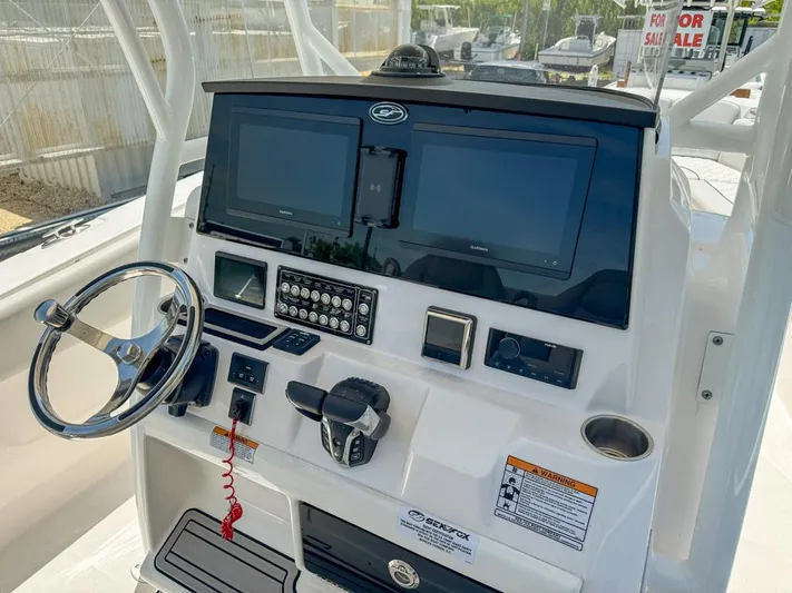  Yacht Photos Pics 2024 Sea Fox 288 Commander boat dashboard with dual screens and controls.