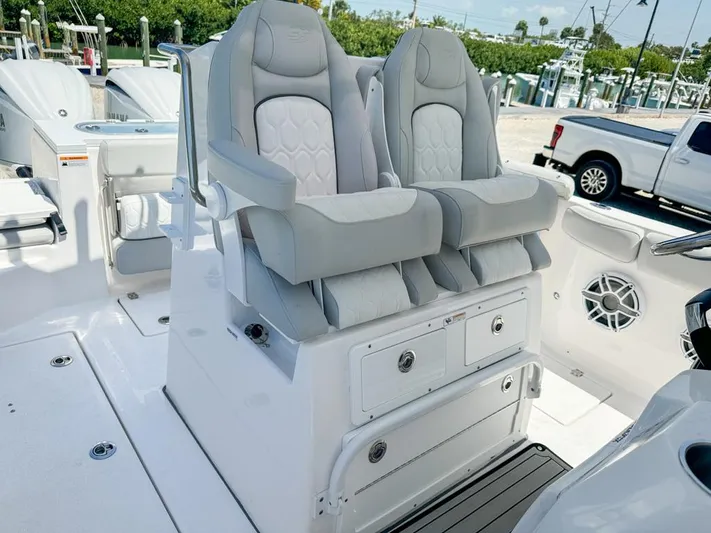  Yacht Photos Pics 2024 Sea Fox 288 Commander boat with dual captain's chairs and storage compartments.