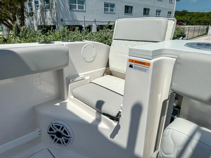  Yacht Photos Pics 2024 Sea Fox 288 Commander boat seating area with white cushioned seats and speaker.