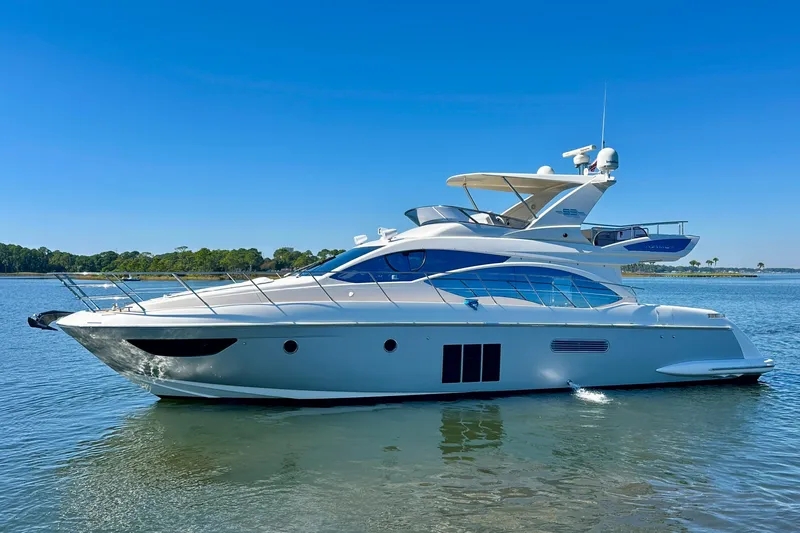  Yacht Photos Pics Luxurious 2011 Azimut Fly 53 yacht cruising on a serene waterway.