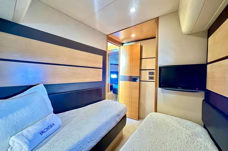  Yacht Photos Pics Luxurious cabin interior of 2011 Azimut Fly 53 yacht with twin beds and TV.