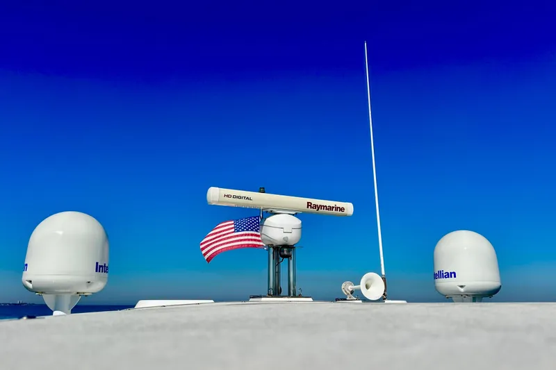  Yacht Photos Pics Azimut Fly 53 yacht radar and antennas with American flag, clear blue sky background.
