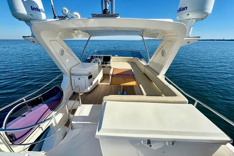  Yacht Photos Pics Luxurious 2011 Azimut Fly 53 yacht with spacious deck and seating, cruising on calm waters.