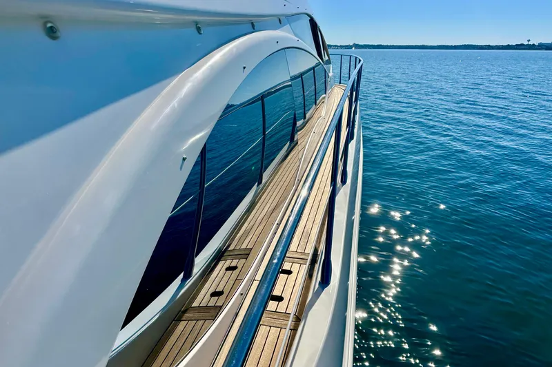  Yacht Photos Pics Side view of 2011 Azimut Fly 53 yacht on sparkling blue water.