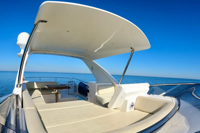  Yacht Photos Pics Luxurious 2011 Azimut Fly 53 yacht deck with seating, under clear blue sky.