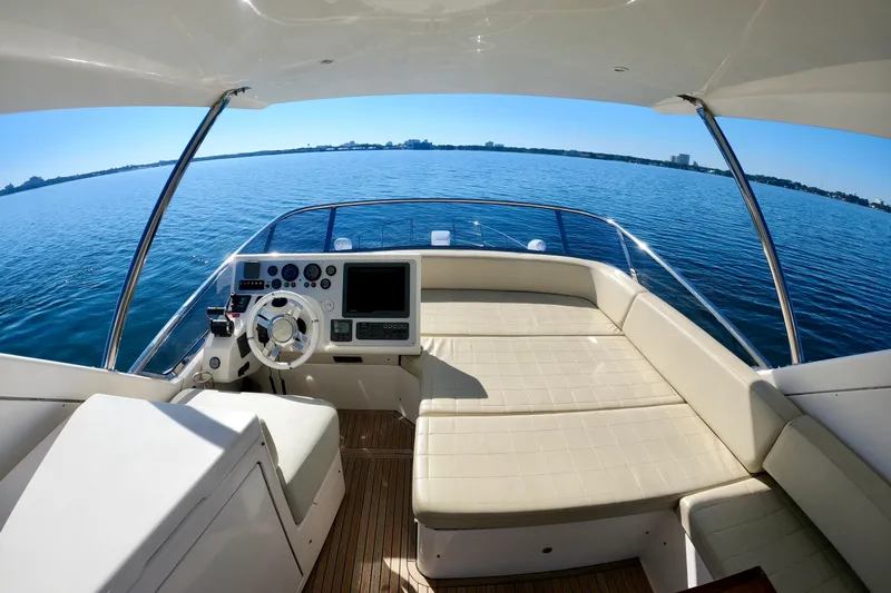  Yacht Photos Pics Luxurious 2011 Azimut Fly 53 yacht interior with helm and seating, overlooking serene blue waters.