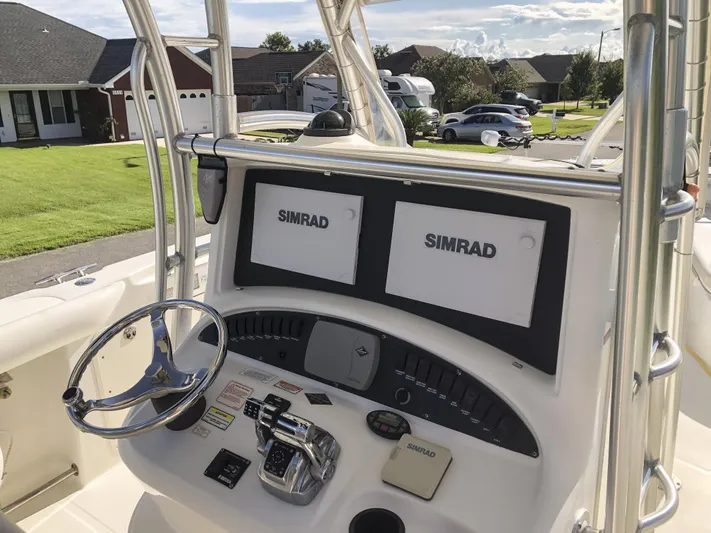  Yacht Photos Pics 2004 Boston Whaler 32 Outrage helm with dual Simrad displays and steering wheel.