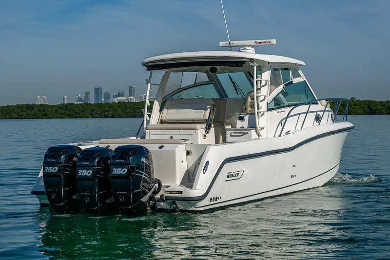  Yacht Photos Pics 2017 Boston Whaler 345 Conquest boat with triple 350 engines on calm water.
