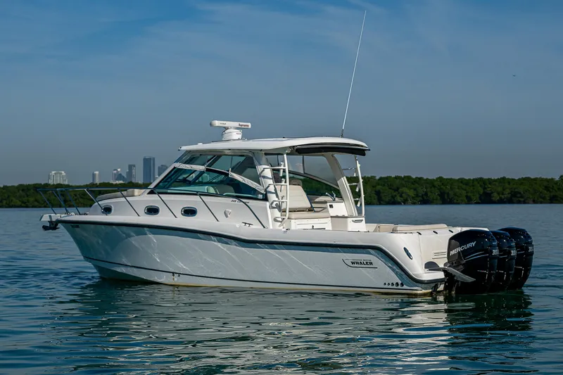  Yacht Photos Pics 2017 Boston Whaler 345 Conquest boat on calm water, side view.