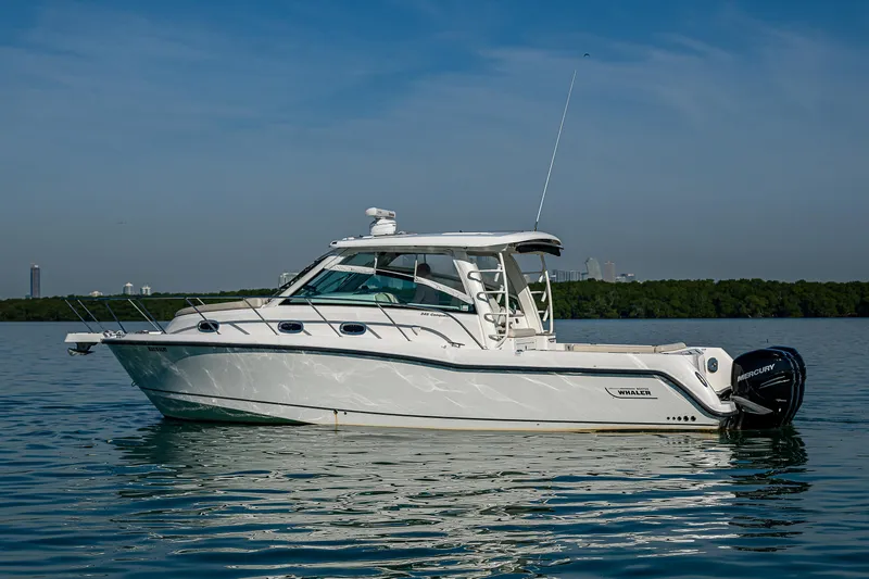  Yacht Photos Pics 2017 Boston Whaler 345 Conquest boat on calm water, side view.