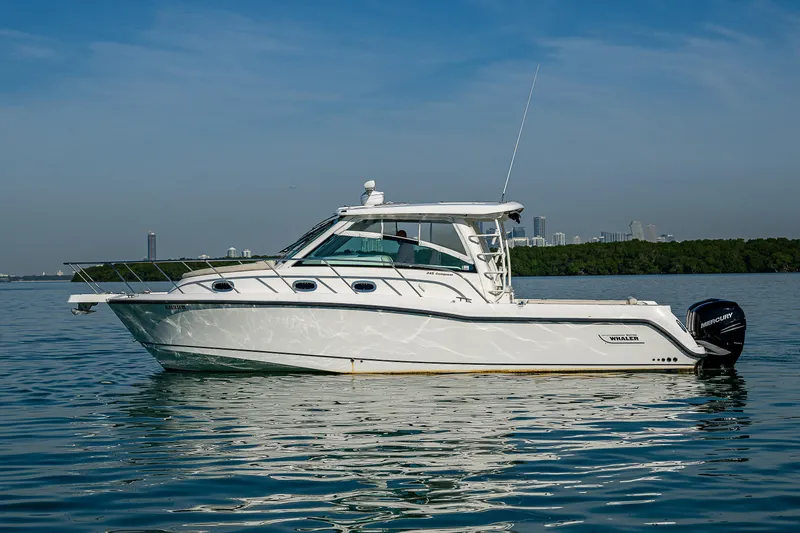  Yacht Photos Pics 2017 Boston Whaler 345 Conquest boat on calm water, side view.