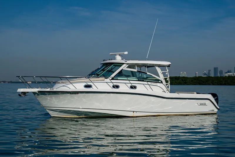  Yacht Photos Pics 2017 Boston Whaler 345 Conquest boat on calm water, clear sky background.