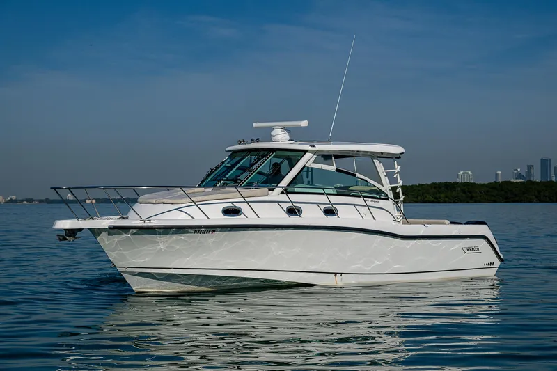  Yacht Photos Pics 2017 Boston Whaler 345 Conquest boat on calm water, clear sky background.