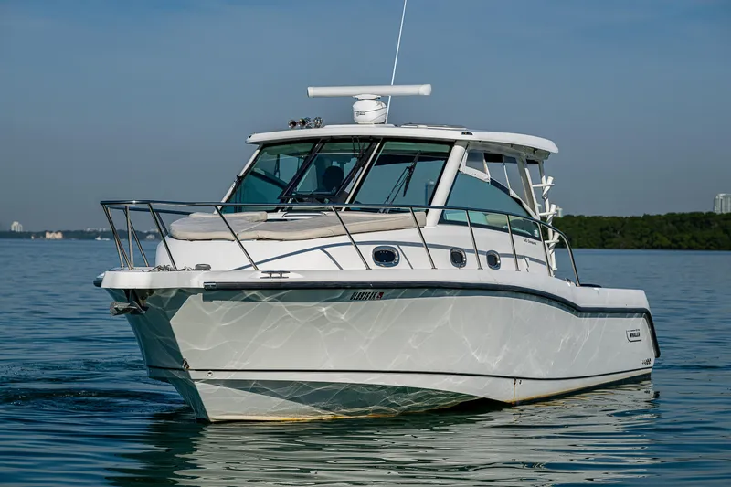  Yacht Photos Pics 2017 Boston Whaler 345 Conquest boat on calm water, side view.