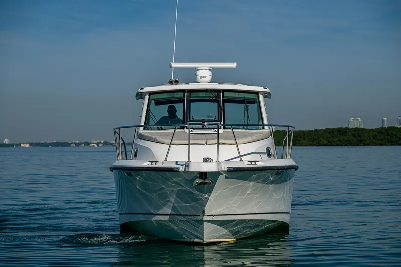 Yacht Photos Pics 2017 Boston Whaler 345 Conquest boat on calm water, front view.