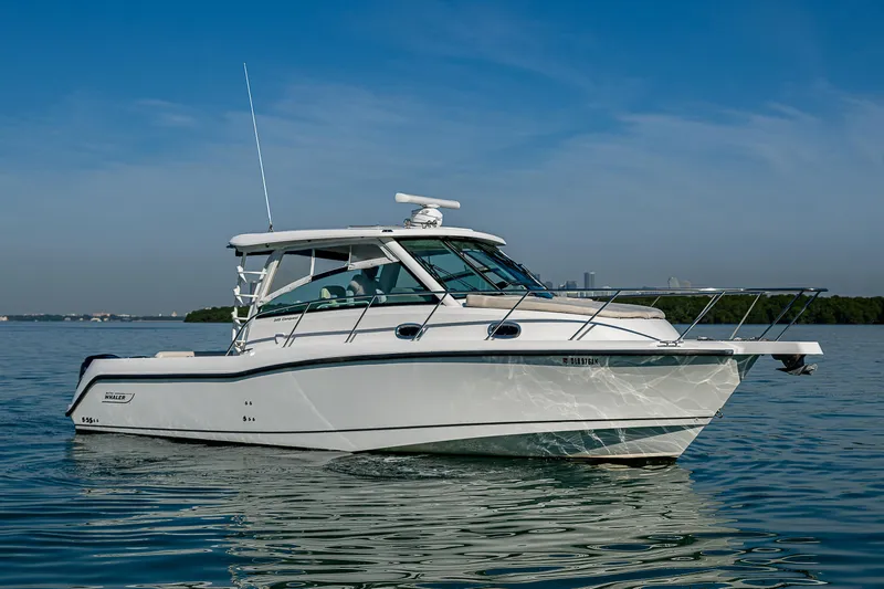  Yacht Photos Pics 2017 Boston Whaler 345 Conquest boat on calm water under clear blue sky.