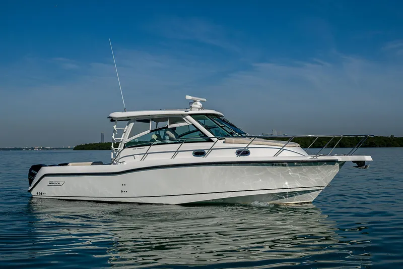  Yacht Photos Pics 2017 Boston Whaler 345 Conquest boat on calm water under clear blue sky.