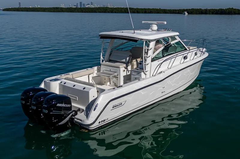  Yacht Photos Pics 2017 Boston Whaler 345 Conquest boat on calm water, rear view.