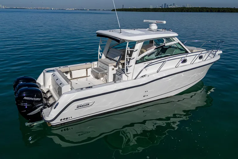  Yacht Photos Pics 2017 Boston Whaler 345 Conquest boat on calm water, featuring twin Mercury engines.