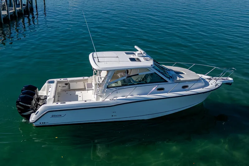  Yacht Photos Pics 2017 Boston Whaler 345 Conquest boat on clear water, side view.