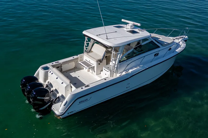  Yacht Photos Pics 2017 Boston Whaler 345 Conquest boat on clear water, featuring twin Mercury engines.