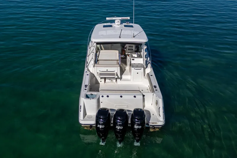  Yacht Photos Pics 2017 Boston Whaler 345 Conquest boat with triple outboard engines on clear water.