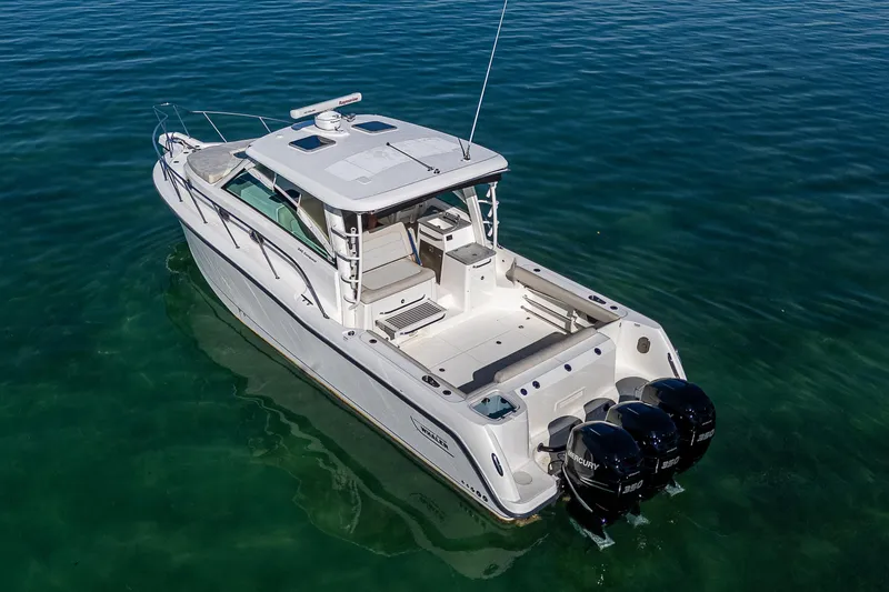  Yacht Photos Pics 2017 Boston Whaler 345 Conquest boat on clear water, rear view.