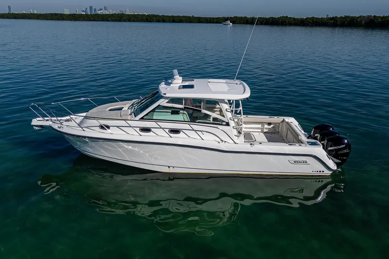  Yacht Photos Pics 2017 Boston Whaler 345 Conquest boat on calm water, side view.