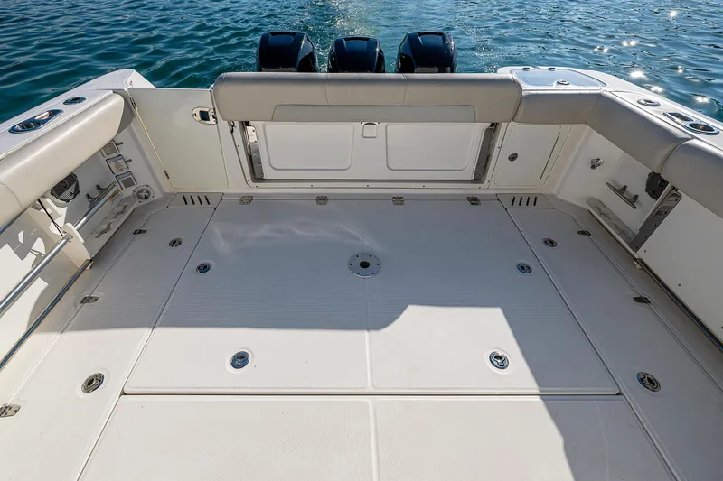  Yacht Photos Pics 2017 Boston Whaler 345 Conquest boat deck with triple engines on calm water.