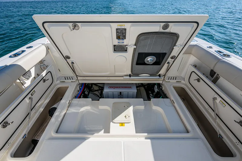  Yacht Photos Pics 2017 Boston Whaler 345 Conquest engine compartment, open hatch, ocean background.