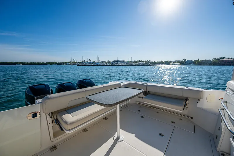  Yacht Photos Pics 2017 Boston Whaler 345 Conquest boat deck with seating, table, and ocean view.