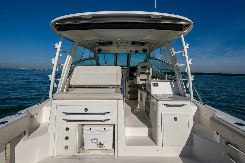  Yacht Photos Pics 2017 Boston Whaler 345 Conquest boat interior with seating and storage, on calm water.