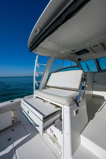  Yacht Photos Pics 2017 Boston Whaler 345 Conquest boat interior with seating and storage, on calm water.