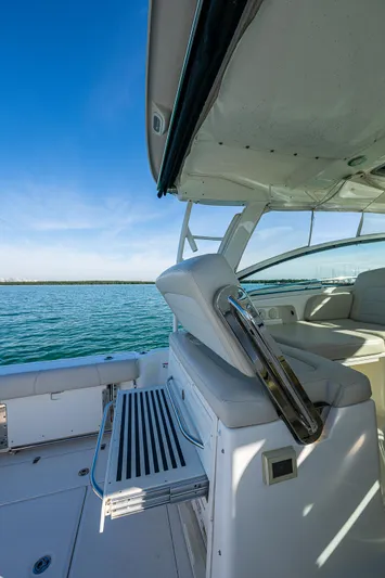  Yacht Photos Pics 2017 Boston Whaler 345 Conquest boat interior with seating, overlooking calm blue waters.