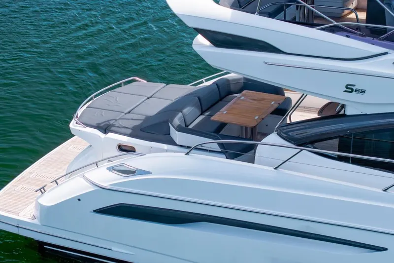  Yacht Photos Pics Luxury 2017 Princess S65 yacht with elegant deck and seating area on water.