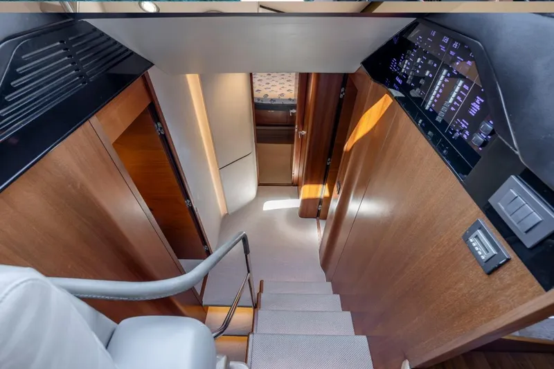  Yacht Photos Pics Staircase in 2017 Princess S65 yacht with wood paneling and control panel.