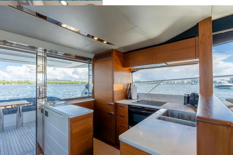 Yacht Photos Pics Luxurious 2017 Princess S65 yacht kitchen with modern wood cabinetry and scenic water views.