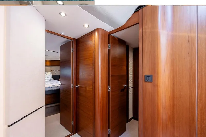  Yacht Photos Pics Luxurious wooden interior of 2017 Princess S65 yacht cabin hallway.