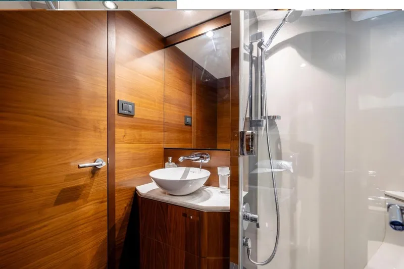  Yacht Photos Pics Luxurious 2017 Princess S65 yacht bathroom with wood paneling and modern fixtures.