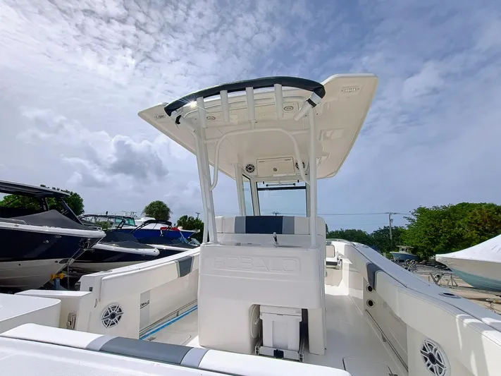 270-152 Yacht Photos Pics 2025 Robalo R270 Center Console boat with T-top under cloudy sky.