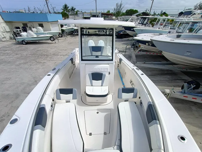 270-152 Yacht Photos Pics 2025 Robalo R270 Center Console boat with spacious seating and modern design in a marina setting.