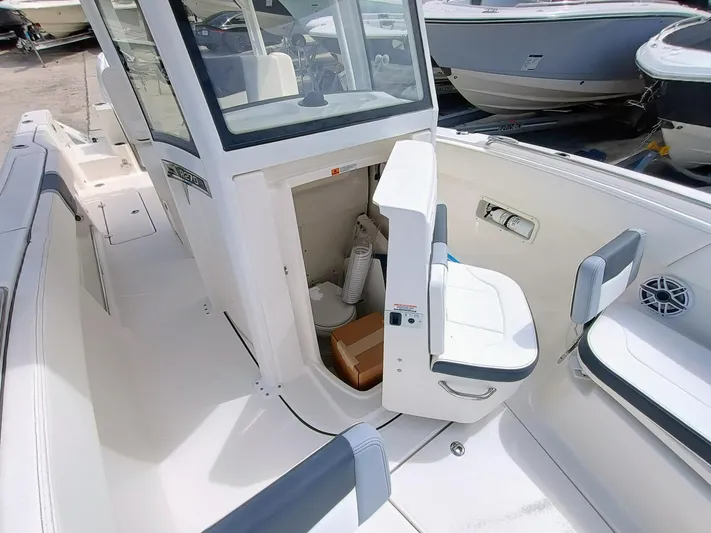 270-152 Yacht Photos Pics 2025 Robalo R270 Center Console boat interior with open storage compartment and seating.